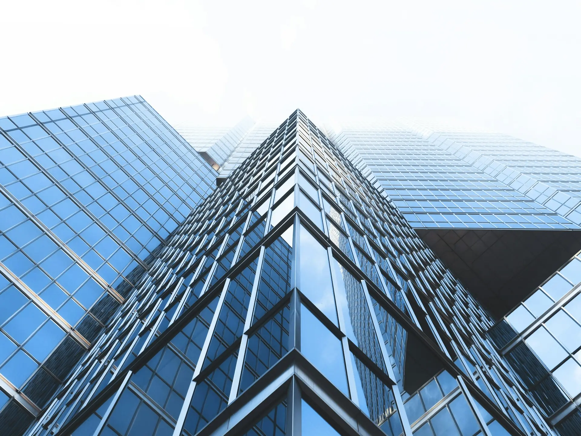 Glass office towers viewed from below.